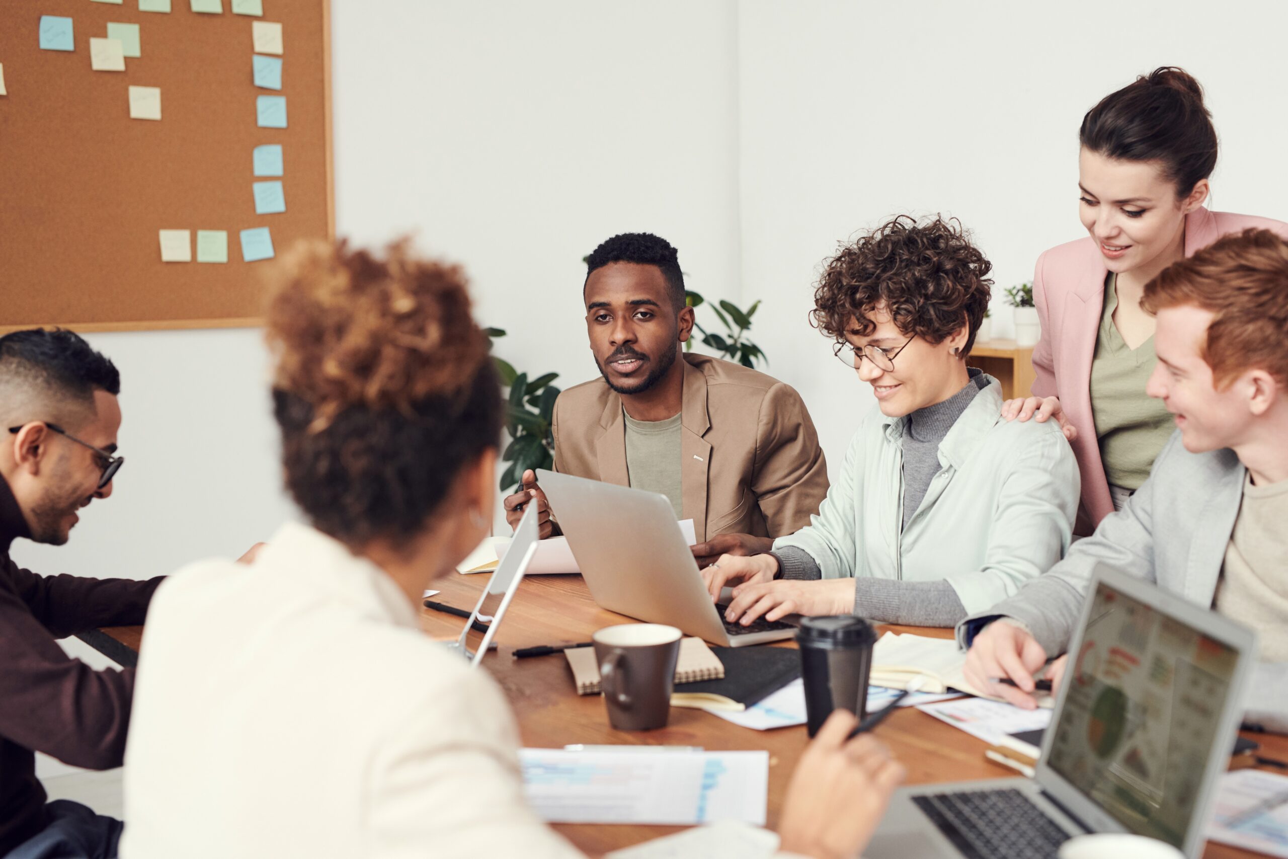 Group of diverse individuals gathered together to work and discuss. From Resignation to Retention.